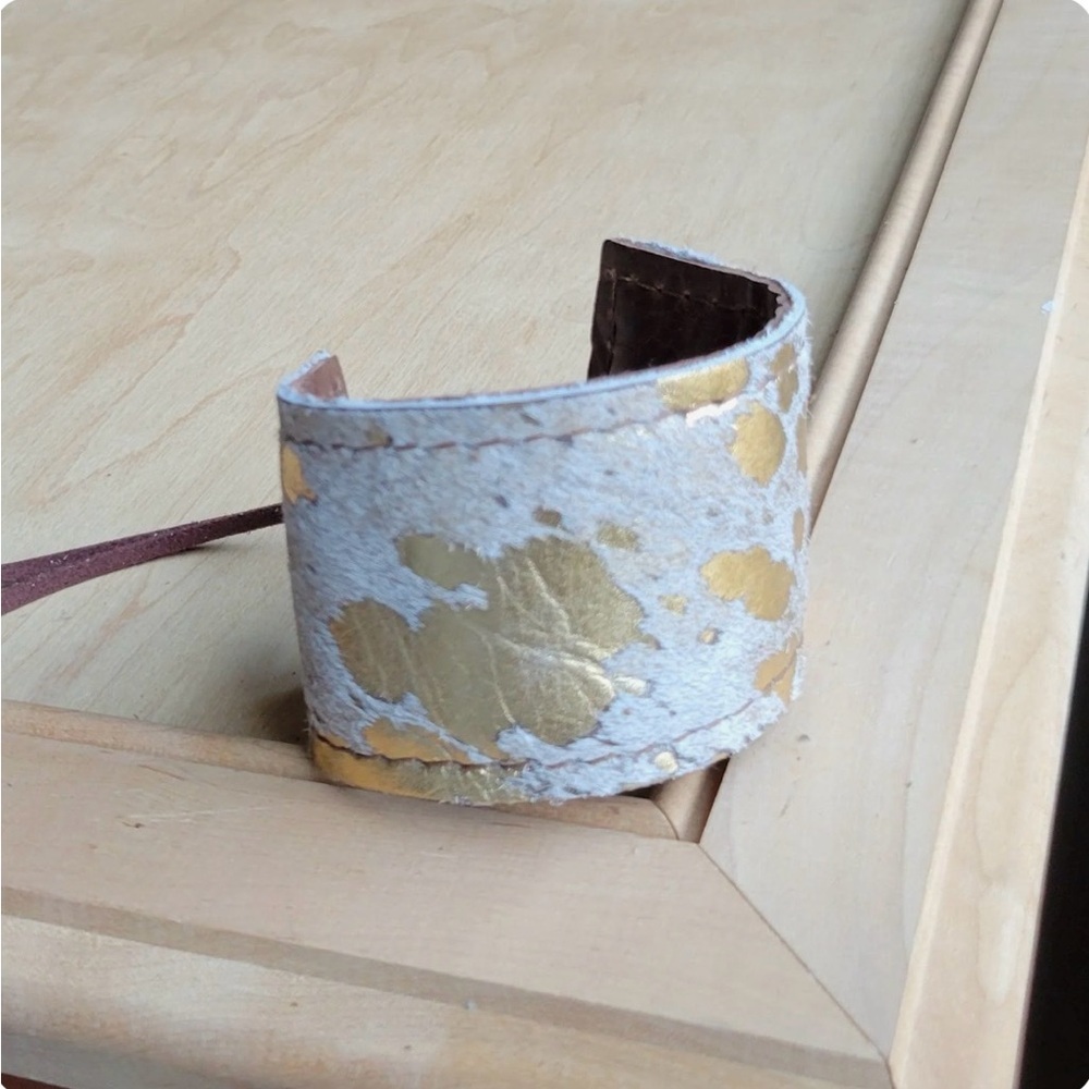 Wide Leather Cuff with cowhide and gold NWT
Just under 2” wide.